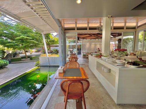 a kitchen with a fish pond in the middle at Field-D House in Koh Tao
