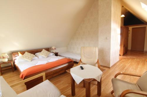 a bedroom with a bed and a table and chairs at Jawor in Zakopane