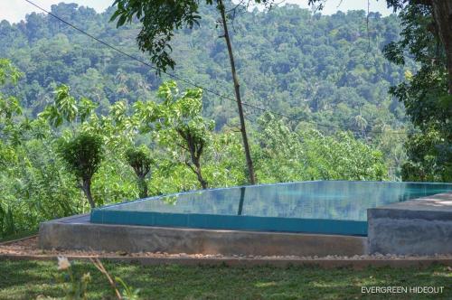 a bench with a view of a mountain at Evergreen Hideout by Tequila Holidays in Kandangama