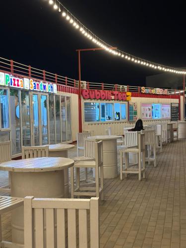 a row of tables and chairs on a patio at night at Baku, Seabreeze, Park Residence 2 in Baku