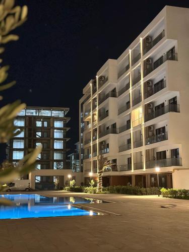 an apartment building at night with a swimming pool at Baku, Seabreeze, Park Residence 2 in Baku