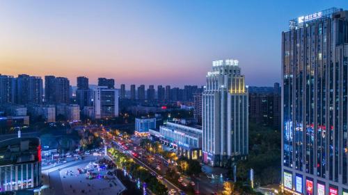 a city skyline at night with a lot of buildings at 长沙珠江花园酒店 in Changsha