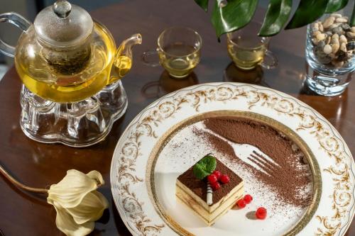 a plate with a piece of cake on a table at 长沙珠江花园酒店 in Changsha