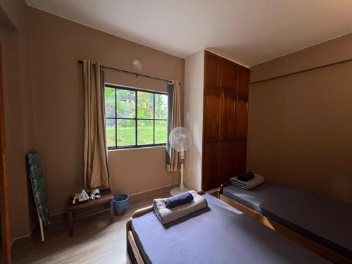 a bedroom with a bed and a window at Lovely apartment in Genting Highlands. in Genting Highlands