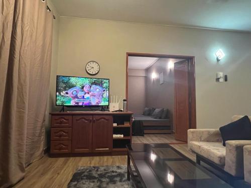 a living room with a flat screen tv and a couch at Lovely apartment in Genting Highlands. in Genting Highlands
