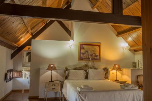 a bedroom with a large bed with wooden ceilings at Reservaloen Hacienda las Marciagas in Benacazón