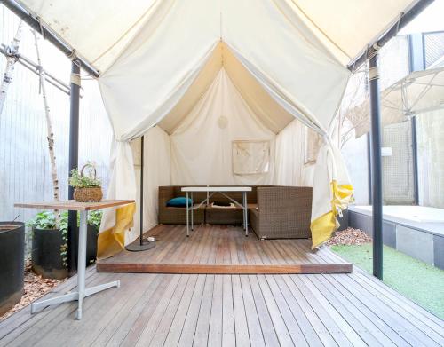 a canvas tent with a desk in it at JS Boutique Hotel in Hwaseong
