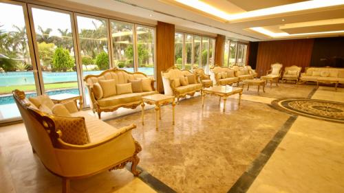 a large waiting room with chairs and a pool at لاكجري صلالة Luxury salalah Villa in Salalah