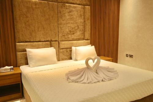 a bed with a white swan decoration on it at لاكجري صلالة Luxury salalah Villa in Salalah