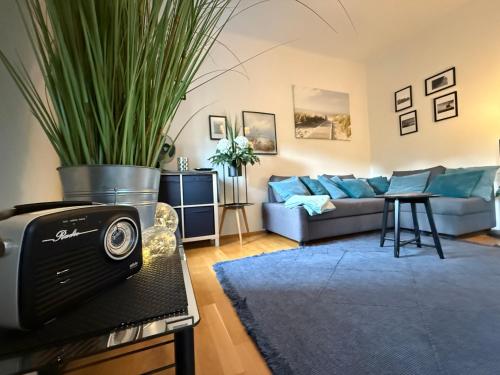 a living room with a couch and a table with a plant at Villa Komposch - adults only in Reifnitz