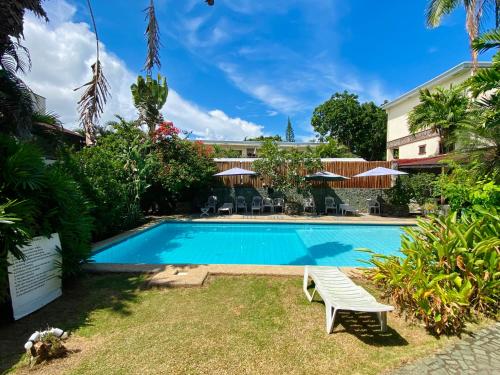 a swimming pool in the yard of a hotel at TipTop Hotel, Resto and Delishop in Panglao
