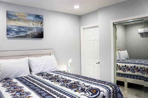 a bedroom with a bed and a painting on the wall at River Lane Studio in Riverview