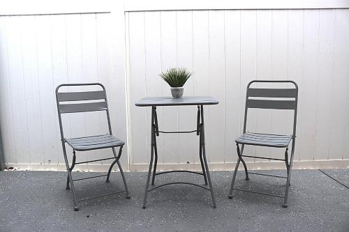 two chairs and a table with a potted plant on it at River Lane Studio in Riverview