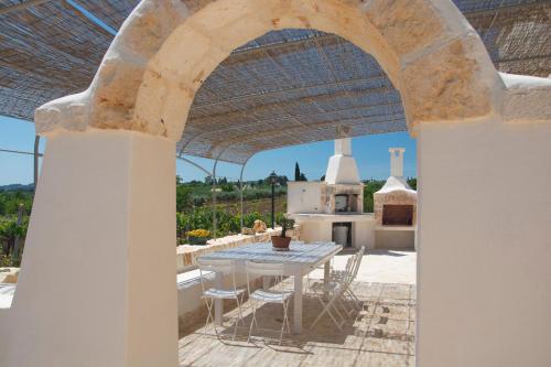 a patio with a table and chairs on a roof at Trulli Laetitia in Martina Franca