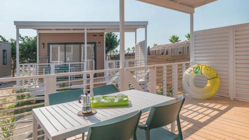 a patio with a table and chairs on a deck at Camping Grande Italia in Chioggia