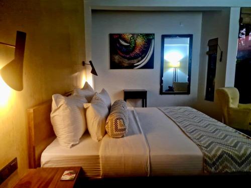 a bedroom with a large bed with white pillows at GlenMyu Estate in Haputale