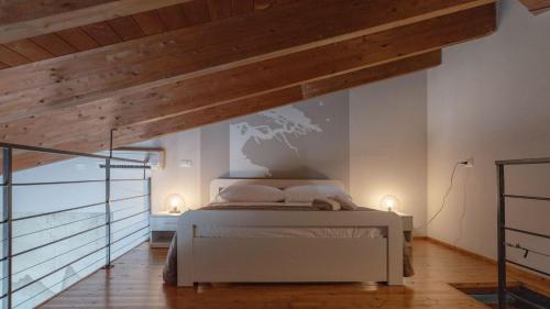 a bedroom with a white bed with a map on the wall at Camping Grande Italia in Chioggia