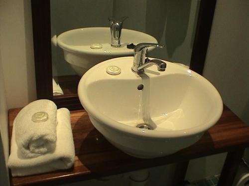 a bathroom with a sink and a mirror at Five Princes Hotel in Suva