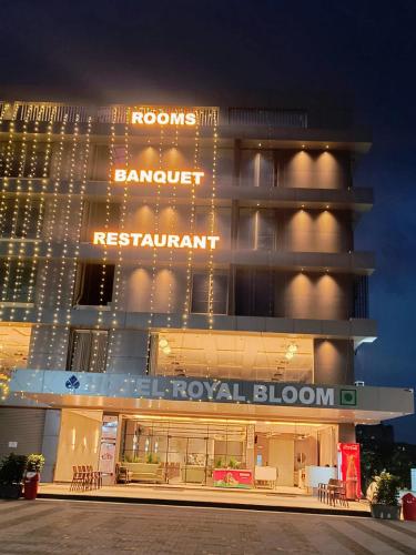 a hotel with a sign on the front of it at Hotel Royal Bloom in Surat