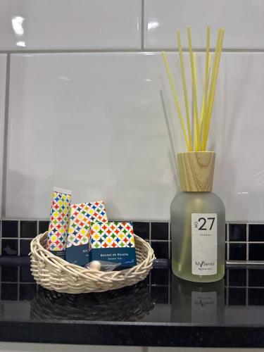 a table with a basket and a vase with a candle at Hotel Am Sportpark in Duisburg