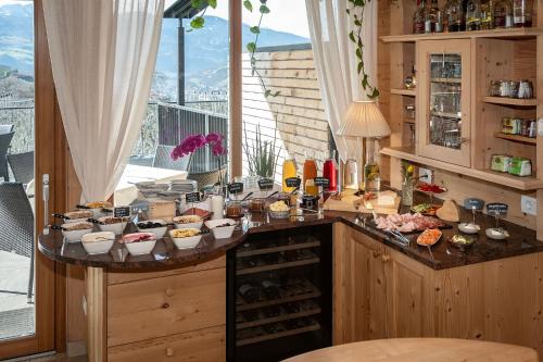 a kitchen with a bunch of food on a counter at Tirolerhof Pension in Naz-Sciaves