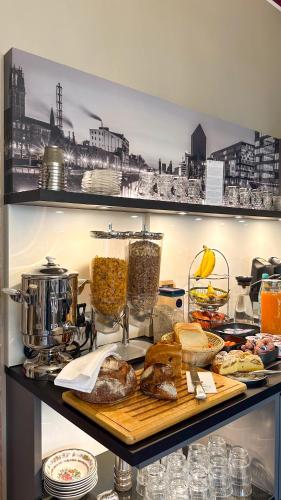 a shelf with bread and other food items on it at Hotel Am Sportpark in Duisburg