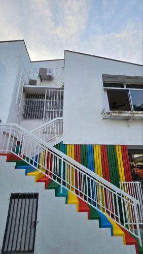 a building with colorful stairs on the side of it at KK Sunset Villa- Full Sunset Balcony, Mosquito Free, 4K TVs, 5G WIFI and more! in Kota Kinabalu