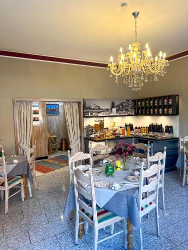 a dining room with a table and a chandelier at Hotel Am Sportpark in Duisburg