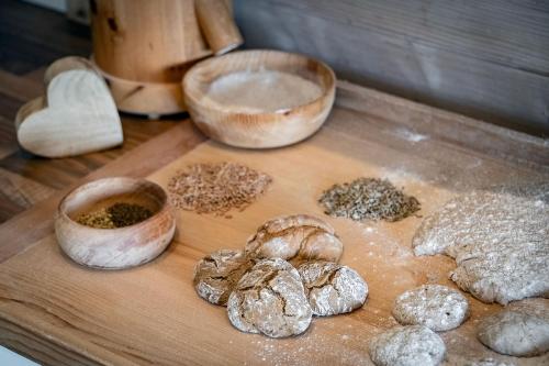 a wooden cutting board with different types of food at Tirolerhof Pension in Naz-Sciaves