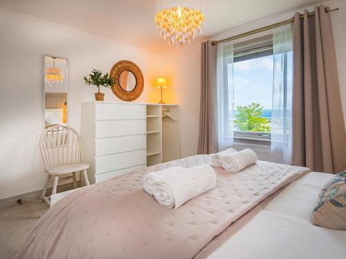 a bedroom with a large bed with a window at Rowan Lodge in Resolis