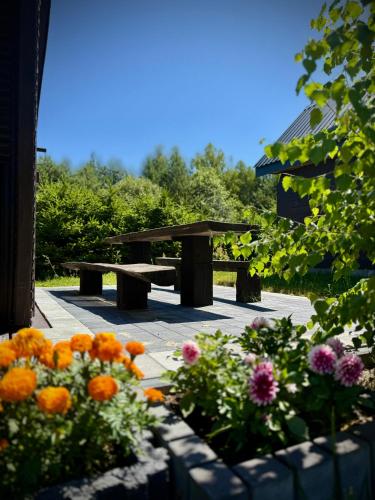 a picnic table and flowers in a park at Zielone Roztocze in Susiec