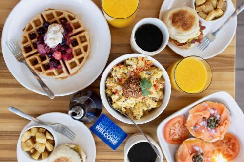a table topped with plates of breakfast foods at voco The Tuxon by IHG in Tucson