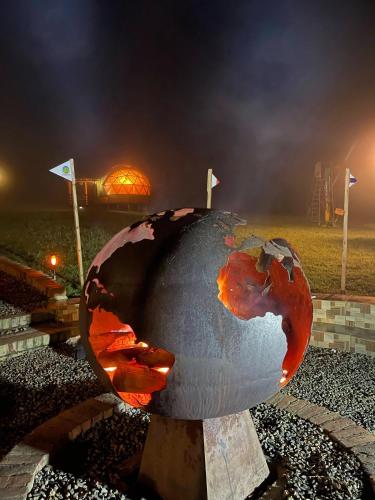 a sculpture of a globe in a park at night at Villa Rebequita in Villapinzón