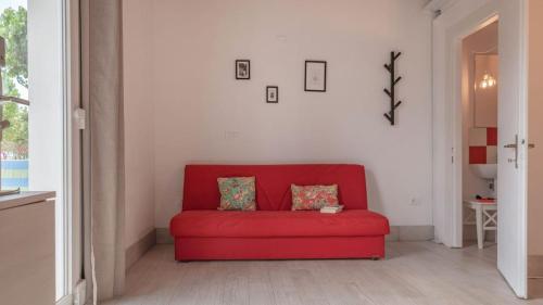 a red couch sitting in a living room at Camping Grande Italia in Chioggia