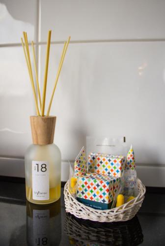 a basket with a bottle of oil and a candle at Hotel Am Sportpark in Duisburg