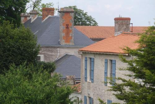 a house with two chimneys on top of it at Château de l'Abbaye - Teritoria in Moreilles