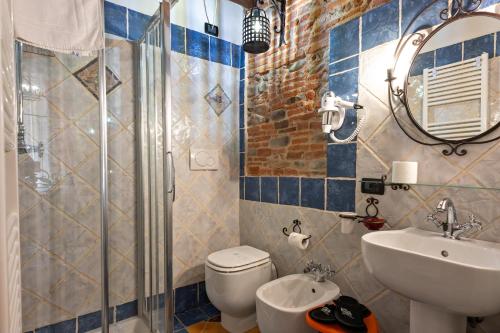 a bathroom with a toilet and a sink and a shower at Antica Corte dei Principi Charming Rooms in Lucca