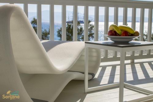 a bowl of fruit sitting on a table on a balcony at Santana Beach in Agia Anna Naxos