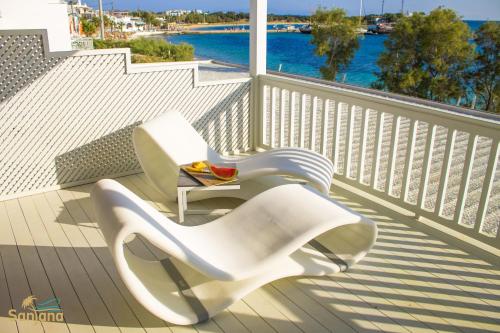 a white chair and a table on a balcony at Santana Beach in Agia Anna Naxos