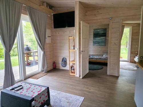 a room with wooden walls and a room with a door at Obuoliu sala Moletu Vila in Gaylyunay