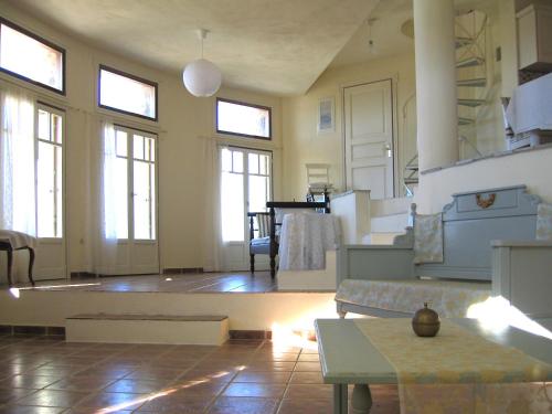 a large living room with windows and a couch at Villa Rotunda in Alonissos Old Town in Alonnisos