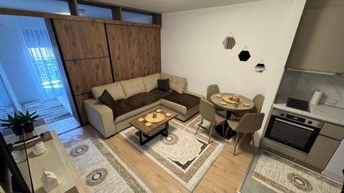 a living room with a couch and a table at APARTMANTES CENTER!!! in Novi Pazar