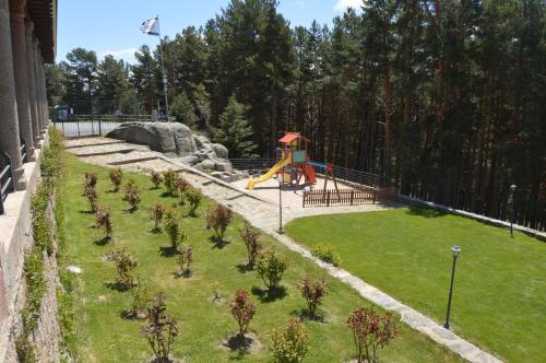 a garden with a playground with at Parador de Gredos in Navarredonda de Gredos