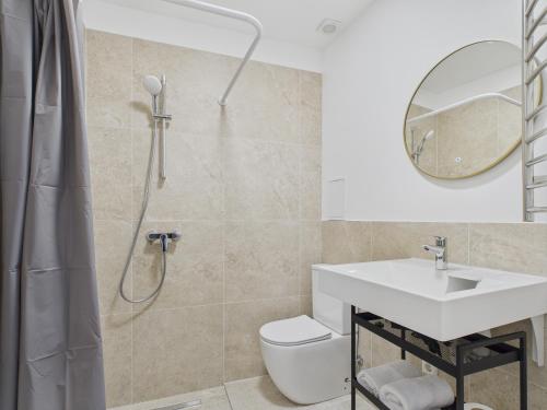 a bathroom with a shower and a sink and a toilet at P6-A Riga Old Town Apartments in Rīga
