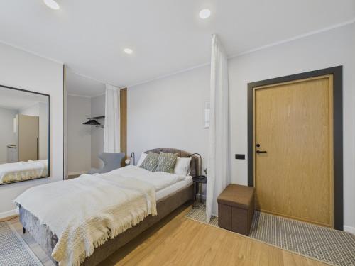 a bedroom with a large bed and a mirror at P6-A Riga Old Town Apartments in Rīga