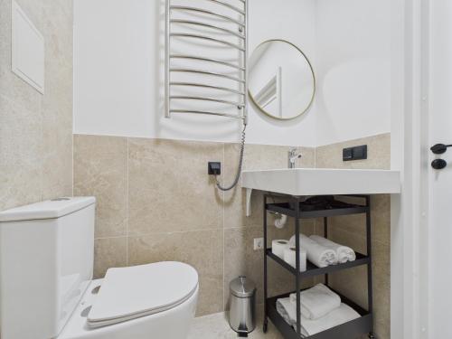 a bathroom with a toilet and a sink and a mirror at P6-A Riga Old Town Apartments in Rīga