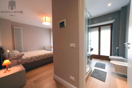 a bedroom with a bed and a bathroom with a sink at B&B Piazza Cavour in Rieti