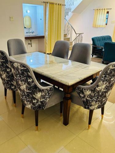 a dining room table with chairs around it at BuddhaInn-An Enchanted Villa in Varanasi