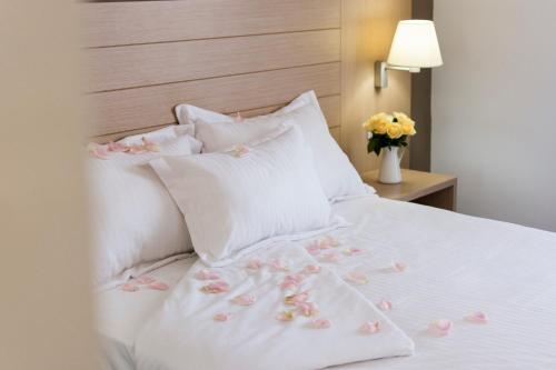 a white bed with pillows and pillows on top of it at Mena Plaza in Nerja