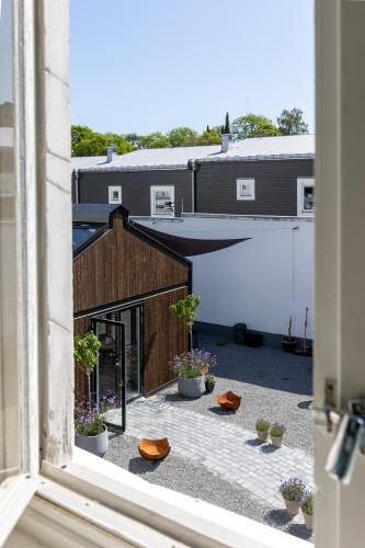 a view from a window of a courtyard with plants at White Brig Guesthouse in Hudiksvall
